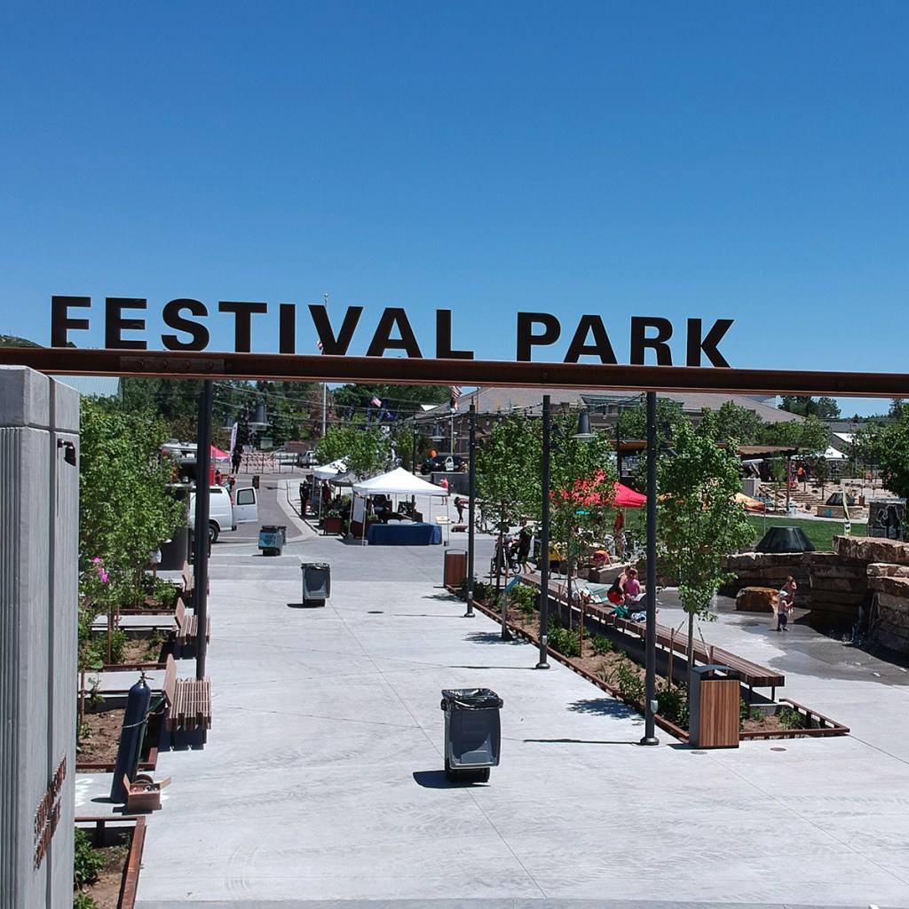 Festival Park entry sign set against a blue sky